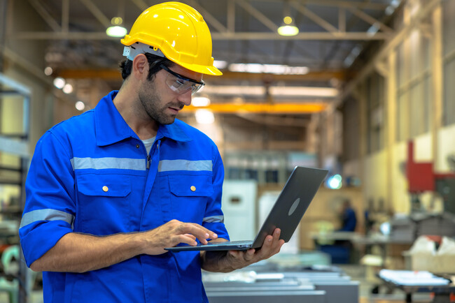 man with laptop in warehouse